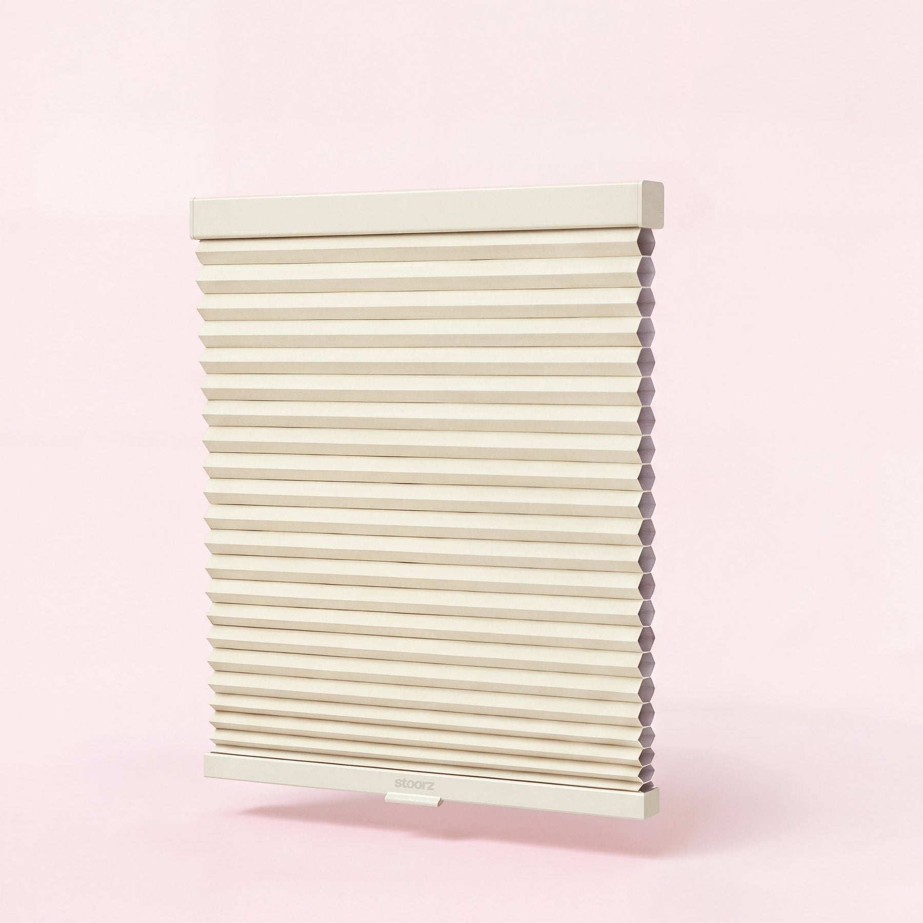 Store Stoorz avec son rail alu à bande adhésive, son tissu plissé et sa barre basse à poignée clipsable